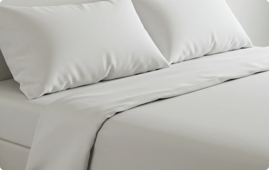 a close up of a white bed
