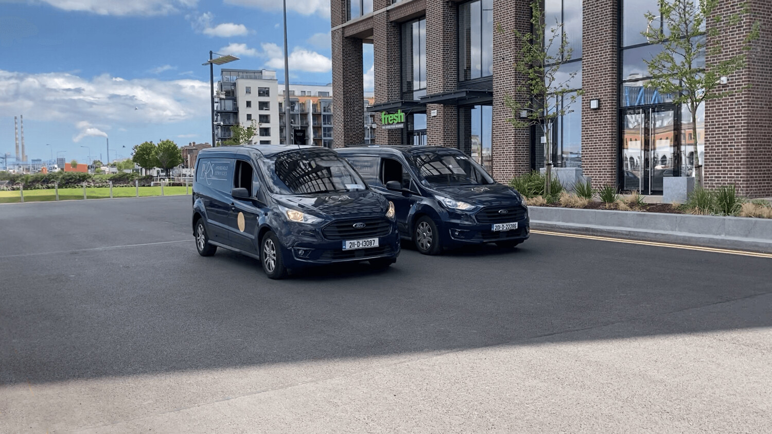 two vans of the company parked outside