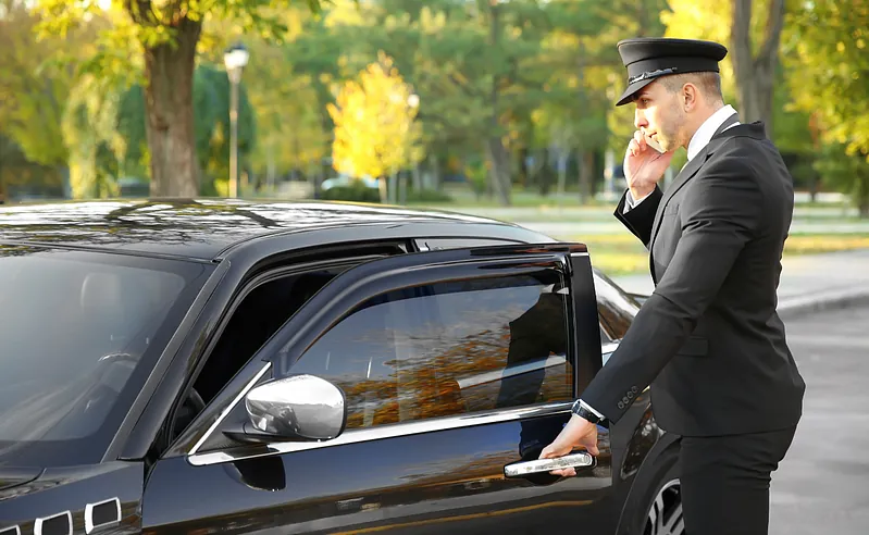 PRS Driver holding the door open